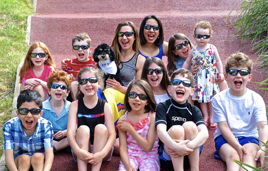 Group of kids and parents wearing sunglasses outdoors